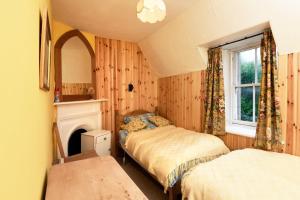 Postel nebo postele na pokoji v ubytování Tower Lodge