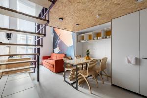 a kitchen and dining room with a table and chairs at Vertical Aparthotel in Saint Petersburg