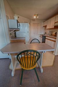 a kitchen with a table and a yellow chair at The Garrison in Wells