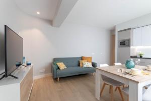 ein Wohnzimmer mit einem blauen Sofa und einem Tisch in der Unterkunft Gernika by Aston Rentals in Gernika