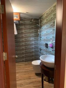 a bathroom with a sink and a toilet in it at Adrasan La Casita Hotel in Adrasan