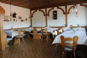 a restaurant with tables and chairs in a room at Appartements Pension Hammerschmied in Lam