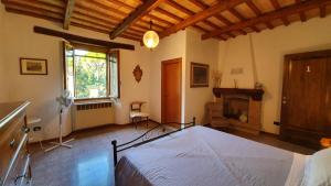 a bedroom with a bed in a room with a fireplace at Affittacamere Villa Molinello in Dovadola
