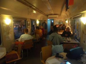 a group of people sitting in a train car at Train Lodge Amsterdam in Amsterdam