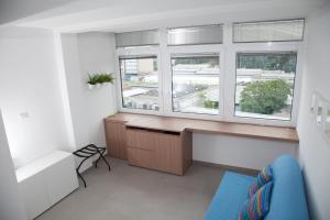 a room with a desk and two windows at Cocor Suites & Design in Naples