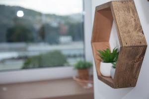 a wooden shelf with plants on a window sill at Cocor Suites & Design in Naples