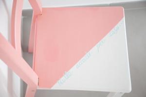 a pink and white chair with a sign on it at Cocor Suites & Design in Naples