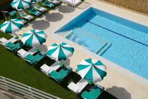 an overhead view of a swimming pool with chairs and umbrellas at Best Western Hotel Rome Airport in Fiumicino