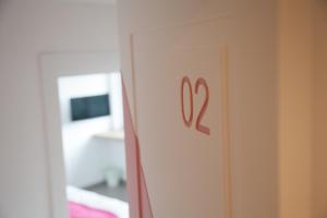 a door with the number on it in a bedroom at Cocor Suites & Design in Naples