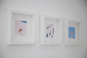 a group of three pictures hanging on a wall at Cocor Suites & Design in Naples