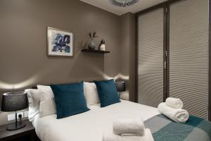 a hotel room with a bed and a window at Mirabilis Apartments - Bayham Street in London
