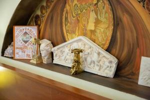 a shelf with a cross and other religious items on it at Hotel Roco in Izvin