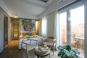 a living room with a bed and a large window at Artree Suites in Heraklio