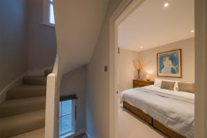 a bedroom with a bed and a stairway at Waterloo Sunset in London