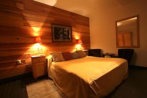 A bed or beds in a room at Mecavnik Resort