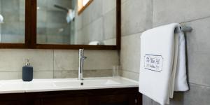 a bathroom sink with a towel and a mirror at The Olive Hill Guesthouse in Batalha +32 photos