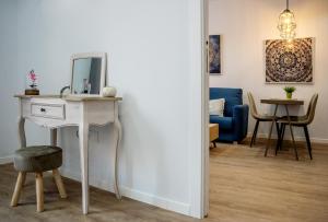 a living room with a table and a blue couch at Apartamentos Turísticos Moret 11 - 2B in Cáceres