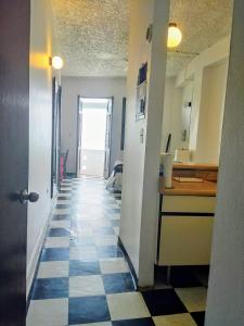 a hallway of an apartment with a checkerboard floor at La Capitana Old San Juan Building in San Juan