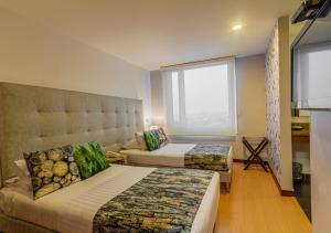 Hotel Factory Green Bogotá客房内的一张或多张床位