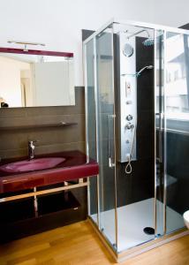 a bathroom with a sink and a glass shower at Jolie Bed And Breakfast in Pescara