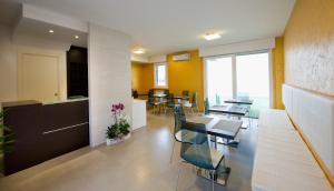 a kitchen and dining room with tables and chairs at Jolie Bed And Breakfast in Pescara