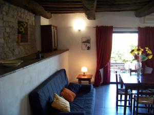 a living room with a blue couch and a table at Appartamenti Valdipetrina in Città di Castello