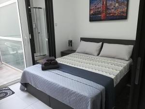 a bedroom with a bed with a towel on it at Nice and cosy apartment close to seafront in Sliema