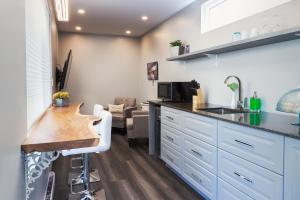 a kitchen with white cabinets and a wooden counter top at Inner Joy Getaways in Elora