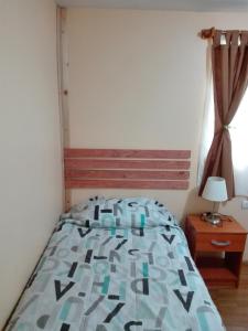 1 dormitorio con cama y ventana en Donde Lupe, en Coyhaique