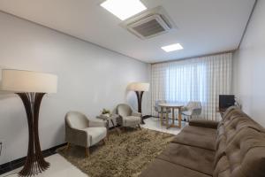 a living room with a couch and chairs and a table at Villa Rio Branco Hotel Concept in Rio Branco