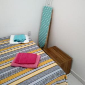 a bedroom with a bed with a mirror on it at Residencial Dom Laurindo in Paulo Afonso