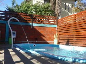 a pool with a water fountain in front of a brick wall at Bungalows Jovi in Colón +32 photos