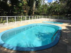 a large swimming pool with a fence around it at Pousada Murici in Barreirinhas