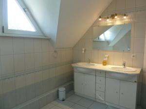a bathroom with two sinks and a mirror at Les cerisiers in Bernardswiller +8 photos