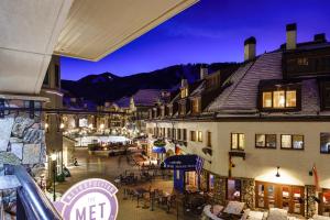 a view of a town at night with tables and chairs at Poste Montane Lodge by East West in Beaver Creek