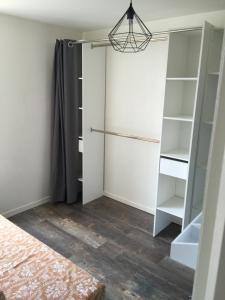 a walk in closet in a bedroom at Le Petit Nid Cosy in Esnandes