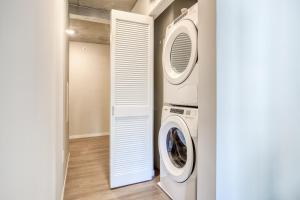 a laundry room with a washer and dryer in it at Mint House Minneapolis - Downtown West in Minneapolis