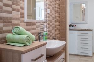 a bathroom with a white sink and a mirror at Holiday Home Tamjan in Supetar +42 photos