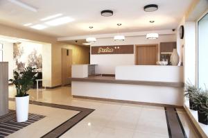 a pharmacy lobby with aania sign on the wall at Arche Hotel Siedlce in Siedlce