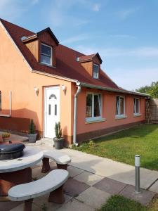 a house with two benches in front of it at Airport16 bed and breakfast in Budapest
