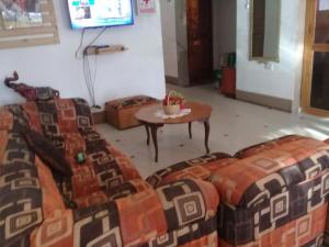 a living room with a couch and a table at Hospedaje Rocha in Ica