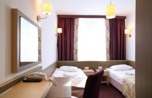Postel nebo postele na pokoji v ubytování Arche Hotel Siedlce
