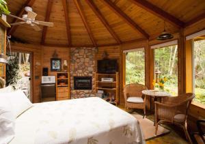 a bedroom with a bed in a wooden cabin at Stormking Hotel in Ashford