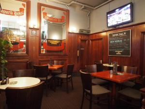 a restaurant with tables and chairs and a chalkboard on the wall at Wynyard Hotel in Sydney