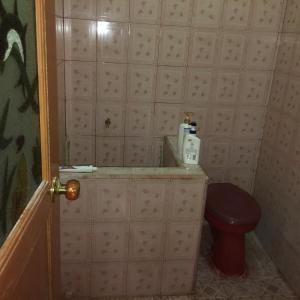 a small bathroom with a toilet in a room at Aini Home Stay in Ternate