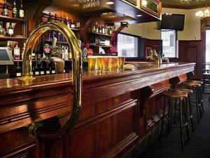 a bar with a wooden counter and some stools at Wynyard Hotel in Sydney