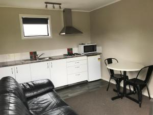 a kitchen with a couch and a table in a room at Twizel Holiday Park in Twizel