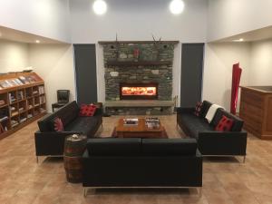 a living room with a couch and a fireplace at Korepo Lodge @ Ruby Bay in Nelson