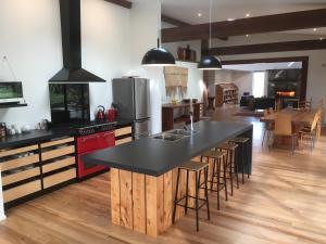 a kitchen with a large island with a black counter top at Korepo Lodge @ Ruby Bay in Nelson