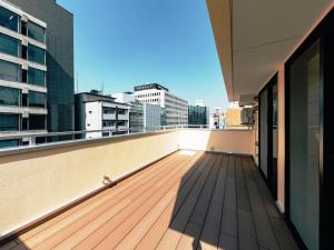 a balcony with a view of a city skyline at Hotel Yururito Osaka in Osaka